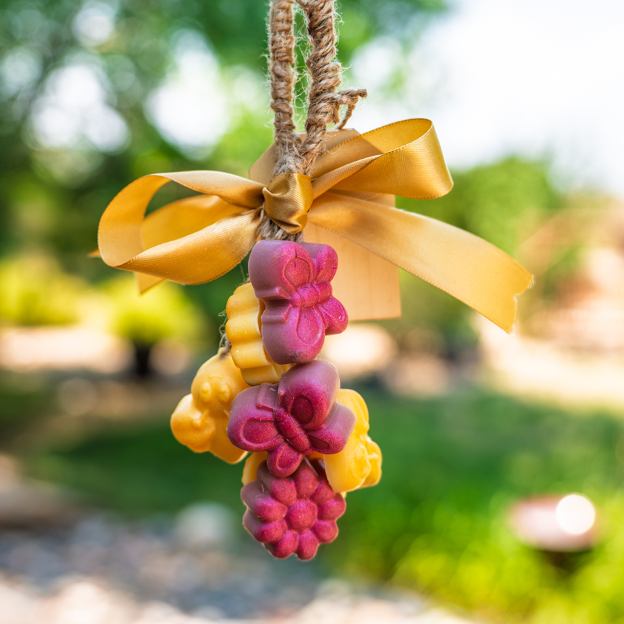 Pink and yellow Sud Buddies hanging hand soap